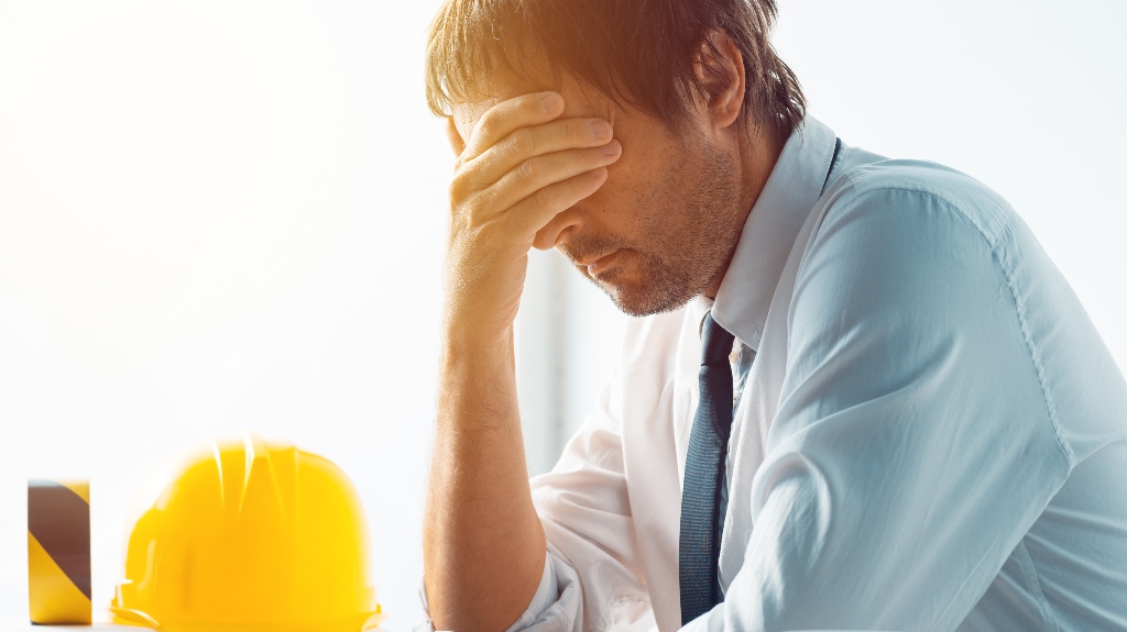construction engineer having problems at work in office
